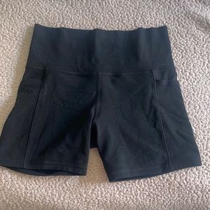 Lululemon Athleta black biker shorts with pockets.